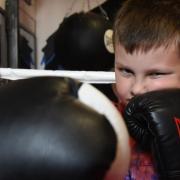 Eight-year-old Xander Waldrom, who has autism, but is benefitting from boxing training. Picture: DENISE BRADLEY