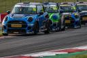 Dan Zelos, in car 445, putting pressure on Mini JCW Challenge race leader Rory Cuff before the Dereham racer was able to find a way past and secure victory at Donington Park Picture: Mark Campbell