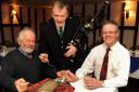 Burns Night celebrations at the Angel at Larling, as piper Ray Russell pipes in the haggis, with landlord Andrew Stammers, right, and his uncle, Dudley Stammers, who is also celebrating his 67th birthday. Picture: Denise Bradley