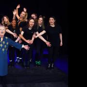 Former music teacher Ina Bullen celebrates her 90th birthday with performing arts company Victory Facade, who are the cast of Six The Musical, during her return to Ormiston Victory Academy