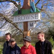 Tom Ewing, Peter Schindler, Christopher Bowers and Ben Ewing (L-R) at the unveiling of the new Trowse village sign