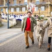 A donkey leads a Palm Sunday procession through Norwich