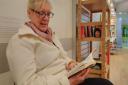 Kim Archer enjoys a book at the honesty library at Castle Mall. Picture: Matt Farmer