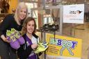 Rev Emily Twigg, right, of the London Road Baptist Church at Lowestoft, with Rebecca Downie, Intu Chapelfield assistant marketing manager, and the perspex box to collect unwanted sports shoes for those in the community who cannot afford them. Picture: DEN