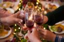 Friends toasting Christmas lunch with a glass of light red wine. Picture: Getty Images/iStockphoto