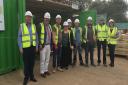 Hethel firm Beattie Passive opens its first flying factory at the Graven Hill development in Oxfordshire. Ron and Rosemary Beattie (far left and far right) with MP Richard Bacon, Graven Hill managing director Karen Curtin, and on-site workers. Picture: