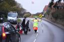 Lollipop lady Jacqui McDonald helps Bacton Primary School children cross the road. Picture: Ian Burt