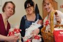 Sisters, Claire Webster, left, and Lianne Smith, right, who started Mummy's Little Bundle, give out their surplus Christmas stock to mums and their babies in the Neonatal Unit at the Norfolk and Norwich University Hospital. One of the recipients is Sophie
