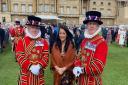 Kerri Parker (centre) with yeoman of the guard inside Buckingham Palace