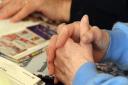 Hands on the memory books at the first Harleston and District Dementia Friendly Community Cafe. PICTURE: Denise Bradley
