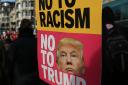 A protestor holds a placard referencing Donald Trump during a demonstration, United for Education, starting at Park Lane in London, over access and quality of higher education. PRESS ASSOCIATION Photo. Picture date: Saturday November 19, 2016. The demonst