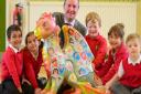 Colman Infant School pupils with their baby GoGoDragon! and Chris Ellis from Dipples who has sponsored a big dragon and will display the baby one in his shop. Picture by SIMON FINLAY.