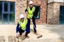 Home manager Nigel Reeve and customer service manager Dan Amis at Mousehold View Care Home laying the last bricks on the home's terrace
