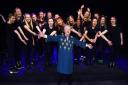 Former music teacher Ina Bullen celebrates her 90th birthday with performing arts company Victory Facade, who are the cast of Six The Musical, during her return to Ormiston Victory Academy