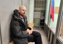 Russian journalist Sergey Karelin appears in court in the Murmansk region of Russia after his arrest on ‘extremism’ charges, which he denied (AP Photo)