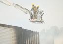 Firefighters on an aerial ladder platform pictured extinguishing the blaze