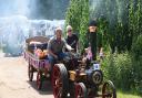 Richard Walton and Christine Burton riding their steam engine through the exhibition at the Strumpshaw steam rally