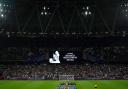 West Ham and FCSB players line up as the big screen displays a message in memoriam following the announcement of the death of Queen Elizabeth II, before the Europa Conference League match at the London Stadium