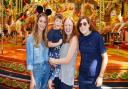 Reality television star Millie Mackintosh (left) with Freddie Skinner, (five), and his parents Laura and Emma Skinner at the Disney Wish experience in Staffordshire in September 2022