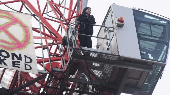 Norwich Evening News: Protester Alex Sidney as he ends his vigil up the crane in Duke Street. Picture: DENISE BRADLEY Norwich Evening News: Protester Alex Sidney as he ends his vigil up the crane in Duke Street. Picture: DENISE BRADLEY