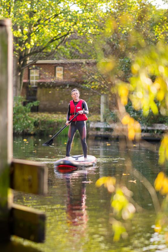 Norwich Evening News: The couple love staying active and regularly paddleboard or swim in the River Wensum near their home at St James Quay Norwich Evening News: The couple love staying active and regularly paddleboard or swim in the River Wensum near their home at St James Quay