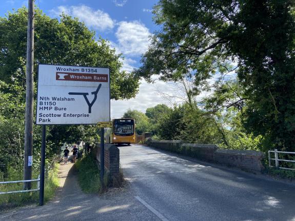 Norwich Evening News: A bus crossing over the bridge out of Coltishall, taking up the width of the road Norwich Evening News: A bus crossing over the bridge out of Coltishall, taking up the width of the road