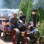 Richard Walton and Christine Burton riding their steam engine through the exhibition at the Strumpshaw steam rally