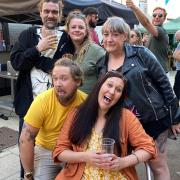 Friends enjoy the atmosphere at the Jubilee street party on King Street in Norwich, hosted by the Last Pub Standing.