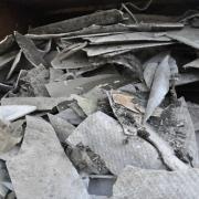 Storage units located just metres from a school and rented by Lee Charles were found to contain piles of asbestos.