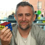 Astronomer Mark Thompson doing a 12-hour Rubik's Cube challenge to complete 100 puzzles for the DEC Ukraine appeal. Pictures: Brittany Woodman