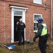 Police enter a property on the Aylsham Road in Norwich during an Operation Gravity drugs raid.