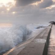 Waves crash against the defences at Walcott, but the risk of a sea change has subsided. Picture: ANTONY KELLY
