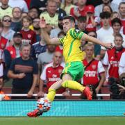 Kenny McLean of Norwich tries to block a shot from Bukayo Saka during City's loss at Arsenal in September