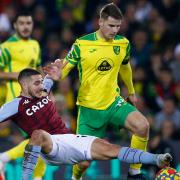 Jacob Sorensen challenges Emi Buendia during Norwich City's loss to Aston Villa