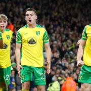 Billy Gilmour and Kenny McLean, centre, celebrate Grant Hanley's goal with the Norwich fans