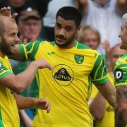 Teemu Pukki thanks Norwich City team-mate Mathias Normann, right, for the assist for his goal against Watford