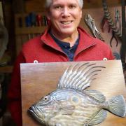 Roger Brookes, fish carver extraordinaire, with his John Dory
