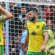 The Norwich players look dejected after conceding their side's fifth goal during the Premier League match at the Etihad Stadium, Manchester