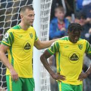 Ben Gibson and Bali Mumba of Norwich look dejected after their side concedes its fourth goal during the Premier League match at the Etihad Stadium, Manchester