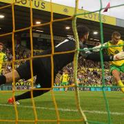 Alisson foils Ben Gibson in Norwich City's 3-0 Premier League defeat to Liverpool