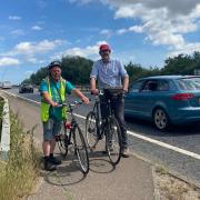 Derek Williams (left) and Peter Silburn from Norwich Cycling Campaign on the narrow shared use bike and pedestrian path by the side of the A47 over the River Yare, on the edge of Norwich