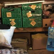 Tracey Cooper inside her Dussindale garage with the piles of donations