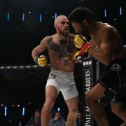 Scott Butters lands punches on Kingsley Crawford in their fight at Cage Warriors 111. Picture: BRETT KING