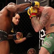 Referee Rich Mitchell steps in to stop the middleweight title fight at Cage Warriors 111, with Nathias Frederick, left, landing heavy shots on champion James Webb. Picture: ROSS HALLS