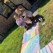 Emily and Sophie Watts have been hard at work colouring in brick walls at their house and their next door neighbour to help brighten up the street, Picture: Leanne Crowley
