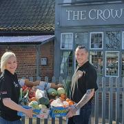 Trina Lake and Bradley Richards with their fruit and vegetable boxes outside The Crown pub in Costessey. Photo: Trina Lake