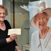 Florist Barbara Tabor who runs Constance Websters Florist in Thorpe St Andrew with her cheque she received from the Queen to supply roses to a Sandringham employee who was in hospital at the time. She kept the cheque as a momento.