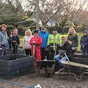 Ruth Burrows (in the red coat) with volunteers next to the new community garden at Sprowston Methodist Church
