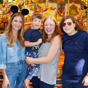 Reality television star Millie Mackintosh (left) with Freddie Skinner, (five), and his parents Laura and Emma Skinner at the Disney Wish experience in Staffordshire in September 2022