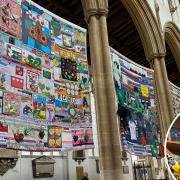 The Grenfell Memorial Quilt is at St Peter Mancroft Church in Norwich this week. Inset: The 'artivist' behind the project, Tuesday Greenidge